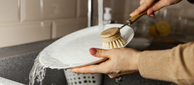 close-up-hands-cleaning-plate