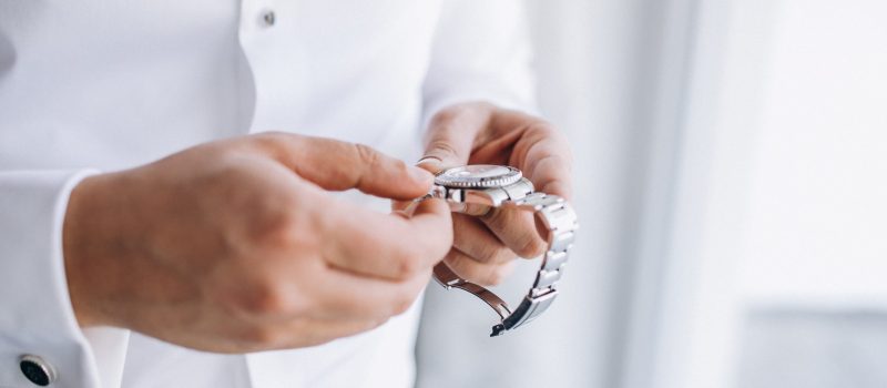 Groom checking time on his wrist watch